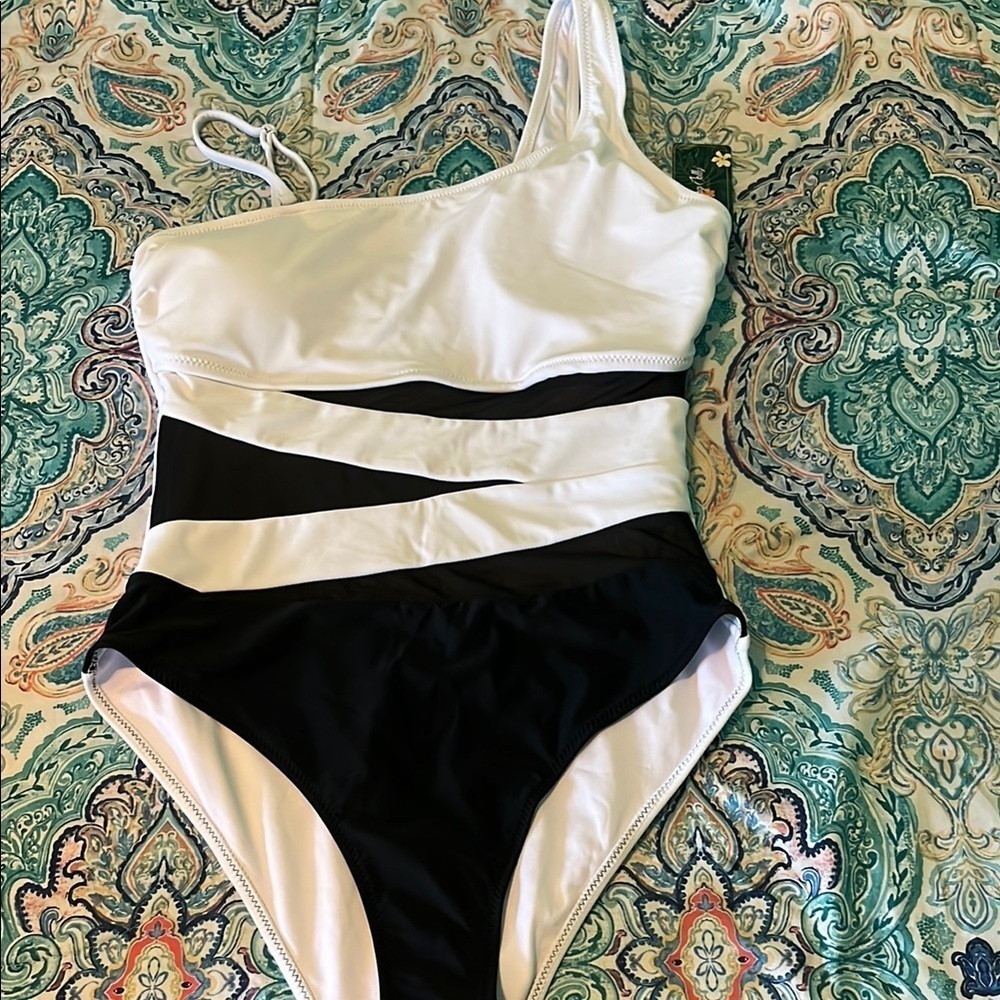 Black and white one piece with mesh inserts.